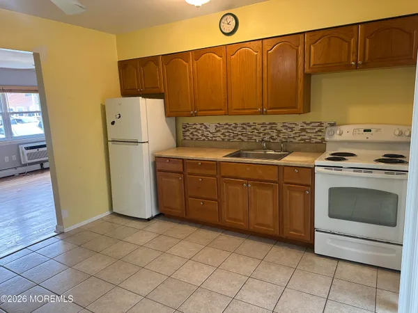 a kitchen with a stove a sink and a refrigerator