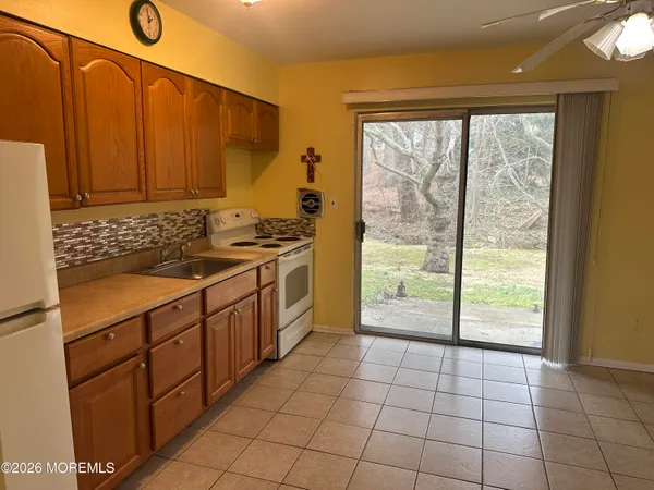 a kitchen with stainless steel appliances a sink window and cabinets