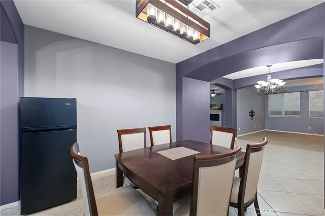 a view of a dining room with furniture and a chandelier