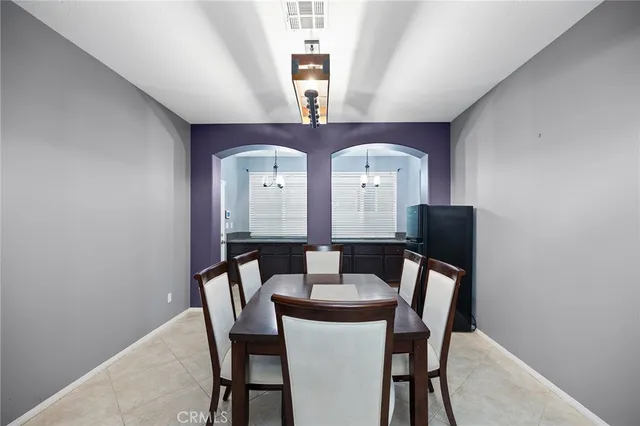 a view of a dining room with furniture and a window