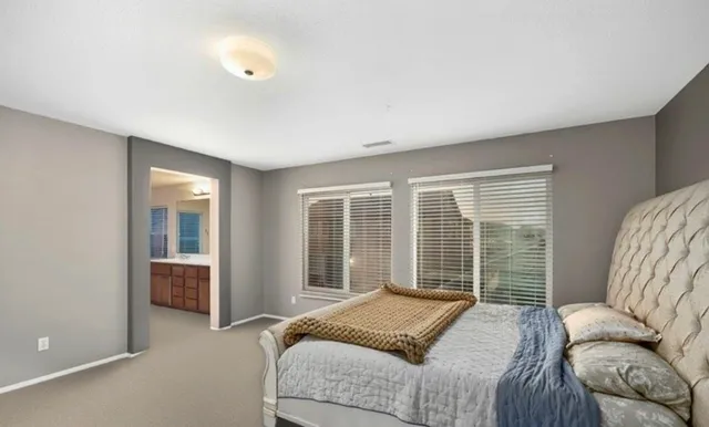 a bedroom with a bed and glass door