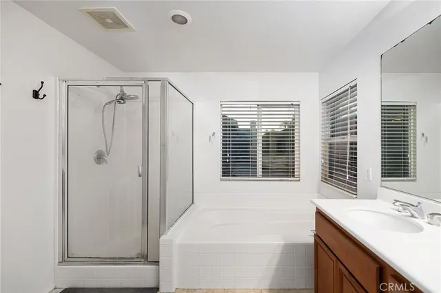 a bathroom with a tub sink and mirror