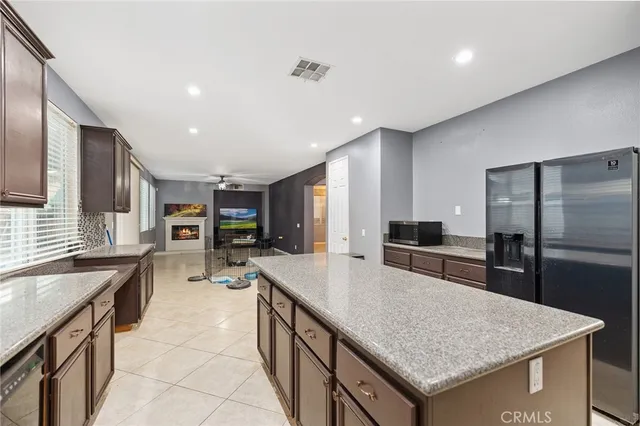 a kitchen with stainless steel appliances granite countertop a sink counter space and refrigerator