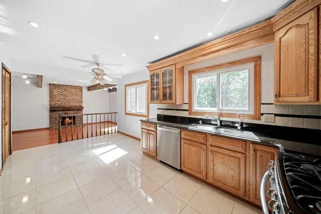 a living room with fireplace furniture and a large window