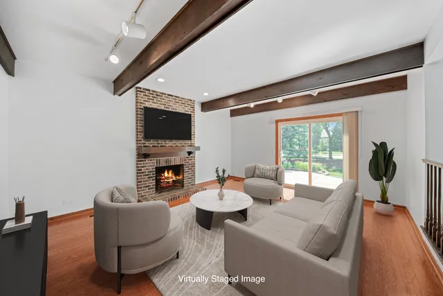 a view of an empty room with a fireplace and a window