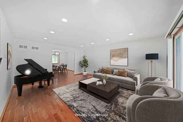 a living room with furniture and wooden floor