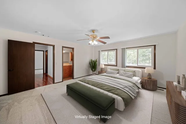 a view of a livingroom with a ceiling fan and window
