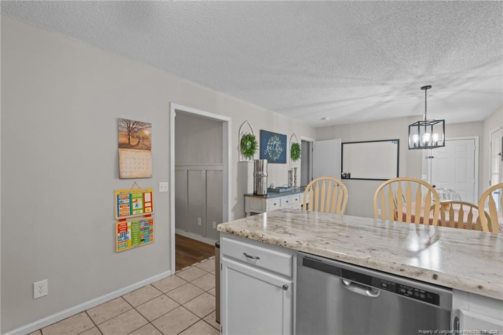 76 North Hillside Drive Spring Lake, NC 28390 - Photo 12 of 50 a kitchen with granite countertop cabinets a stove and a dining table