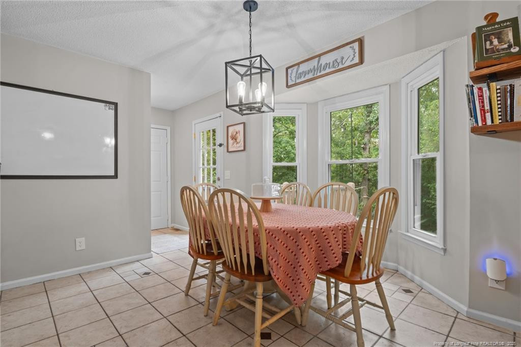 76 North Hillside Drive Spring Lake, NC 28390 - Photo 14 of 50 a view of a dining room with furniture window and chandelier