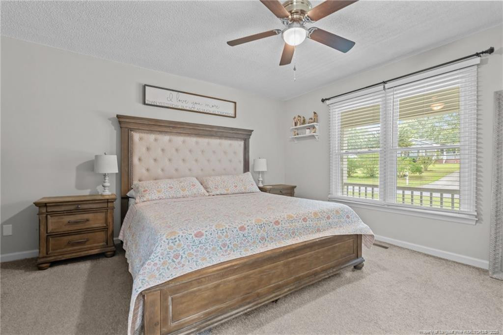 76 North Hillside Drive Spring Lake, NC 28390 - Photo 17 of 50 a bedroom with a bed and a chandelier