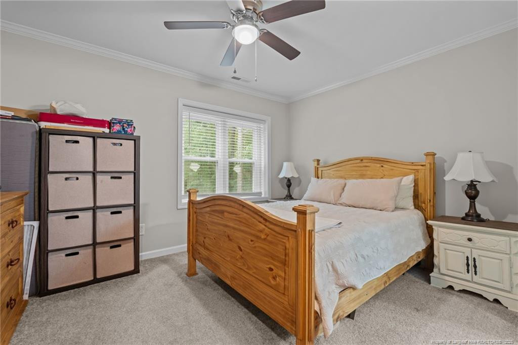 76 North Hillside Drive Spring Lake, NC 28390 - Photo 19 of 50 a bedroom with a bed and a chandelier