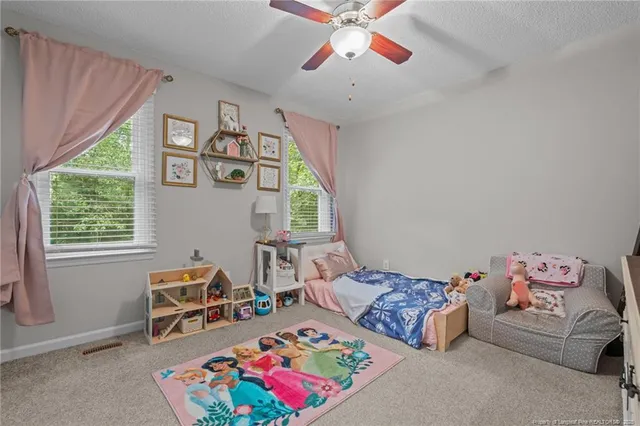 a bedroom with furniture and a window