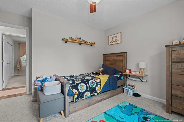 a bedroom with furniture and a wooden floor