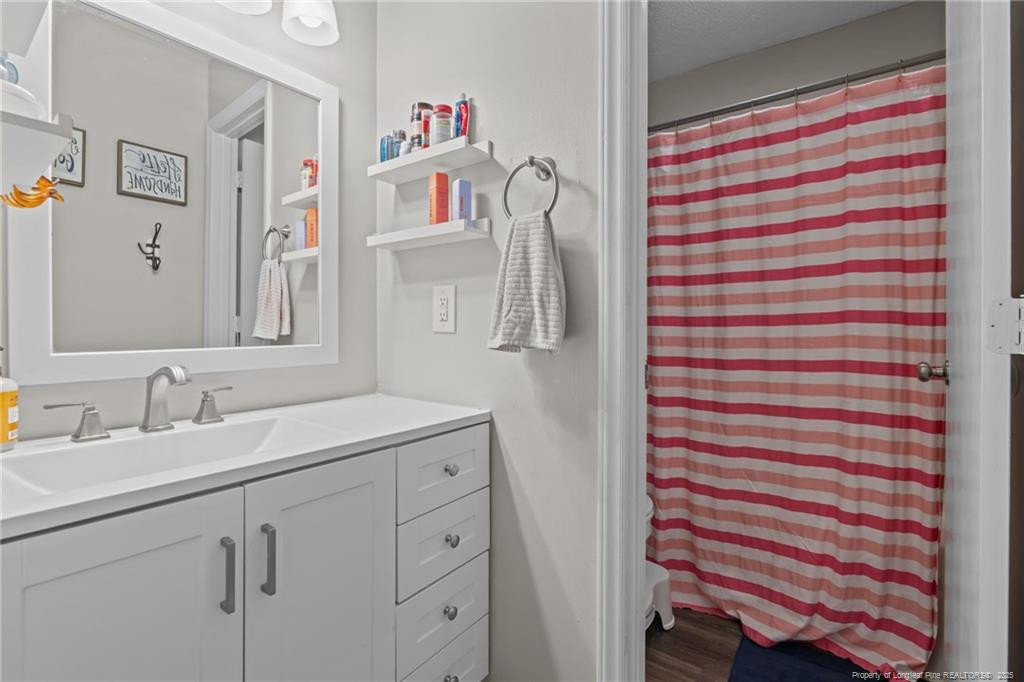 76 North Hillside Drive Spring Lake, NC 28390 - Photo 26 of 50 a bathroom with a sink and a mirror