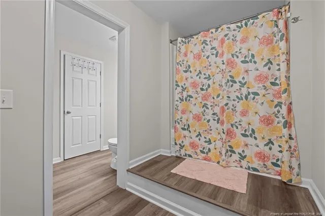 a bathroom with a bathtub and shower