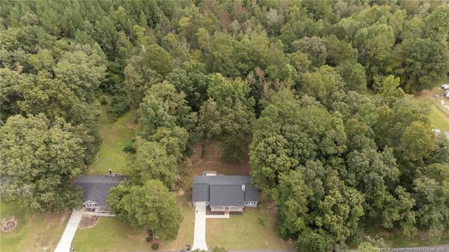 an aerial view of a house with a yard