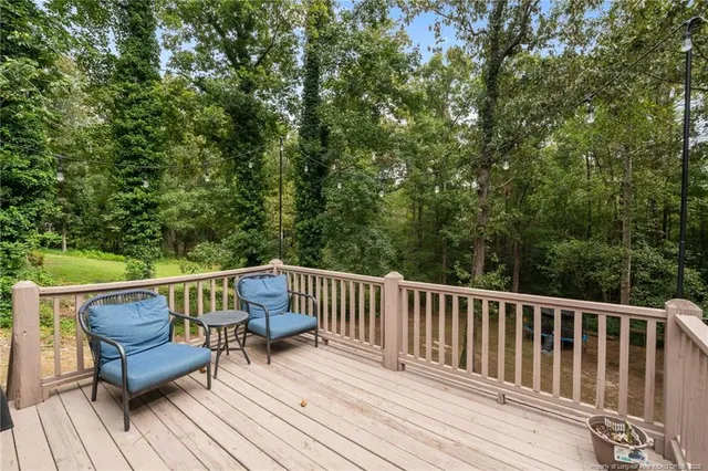 a view of roof deck with furniture and trees