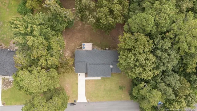 an aerial view of a house with a yard