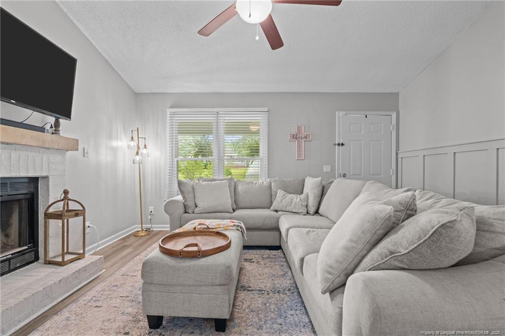 76 North Hillside Drive Spring Lake, NC 28390 - Photo 6 of 50 a living room with furniture a flat screen tv and a fireplace