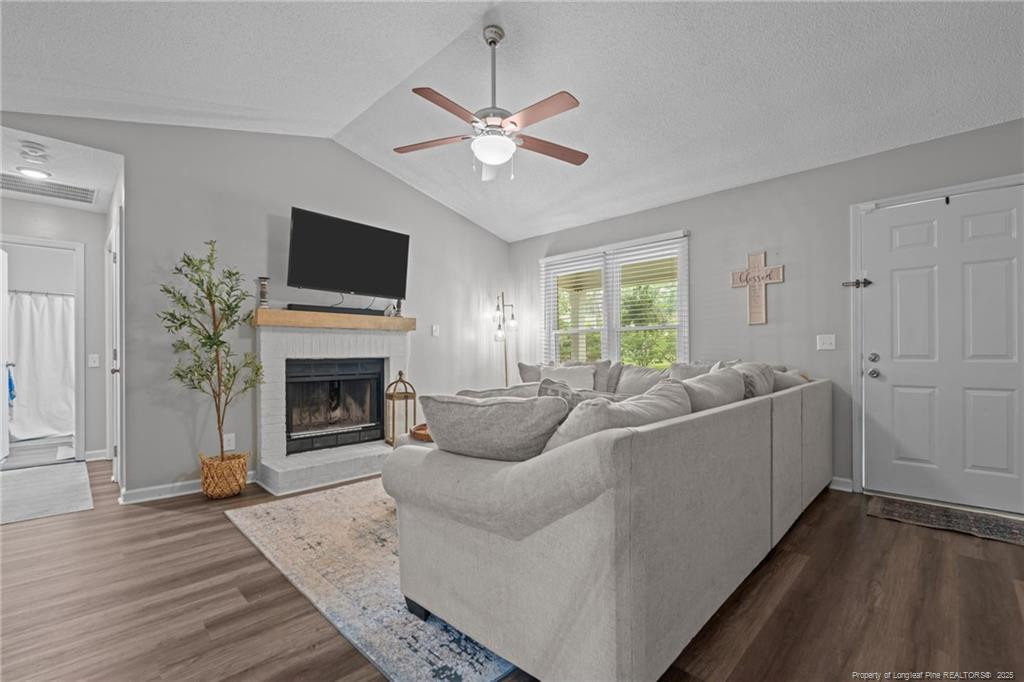 76 North Hillside Drive Spring Lake, NC 28390 - Photo 7 of 50 a living room with furniture a fireplace and a flat screen tv