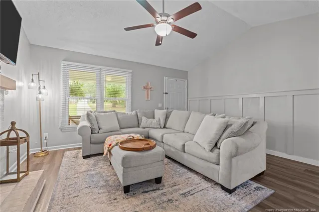 a living room with furniture and a flat screen tv