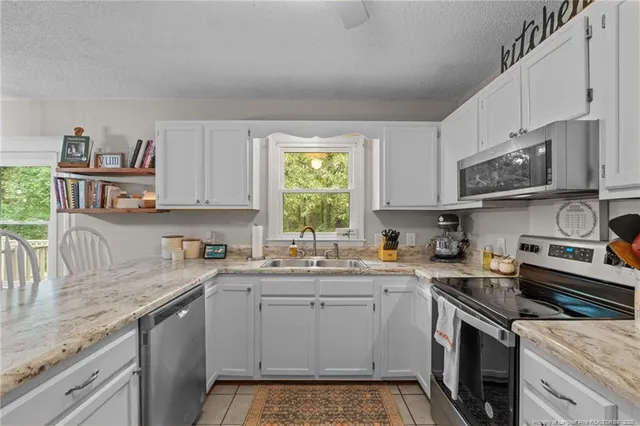 a kitchen with a sink stove top oven and cabinets