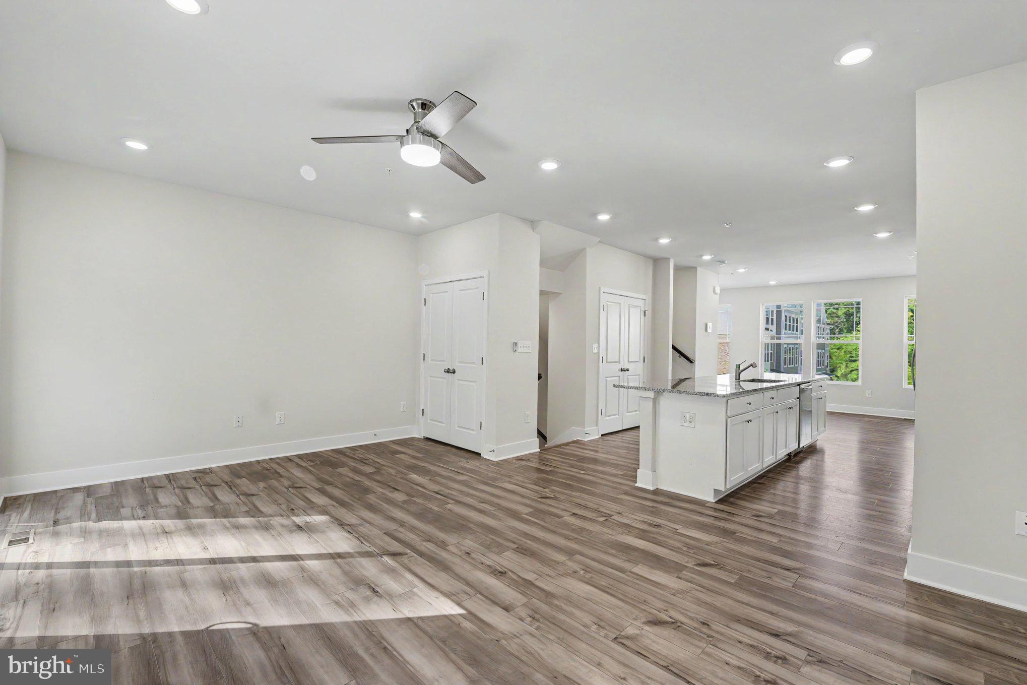 238 Waterstone Road Essex, MD 21221 - Photo 20 of 39 a view of kitchen with kitchen island white cabinets and wooden floor