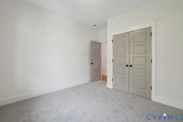 an empty room with closet area