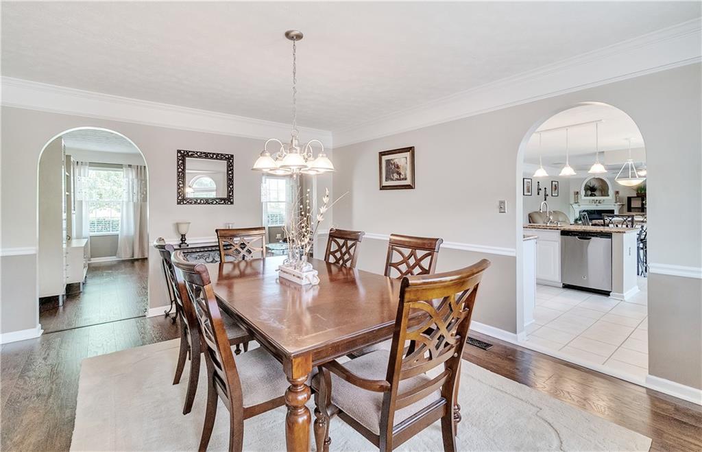690 Gamble Road Oakdale, PA 15071 - Photo 5 of 24 Formal dining room with crown molding, chair rail, beautiful luxury laminate flooring. Bay window behind, not visible. View of massive kitchen to the right.