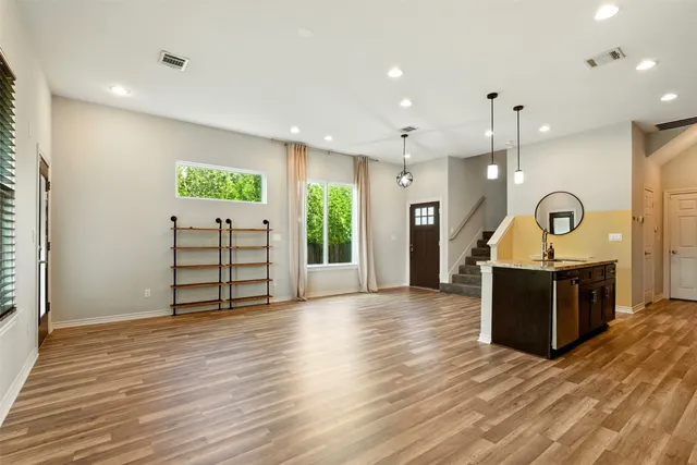a view of a hallway with wooden floor