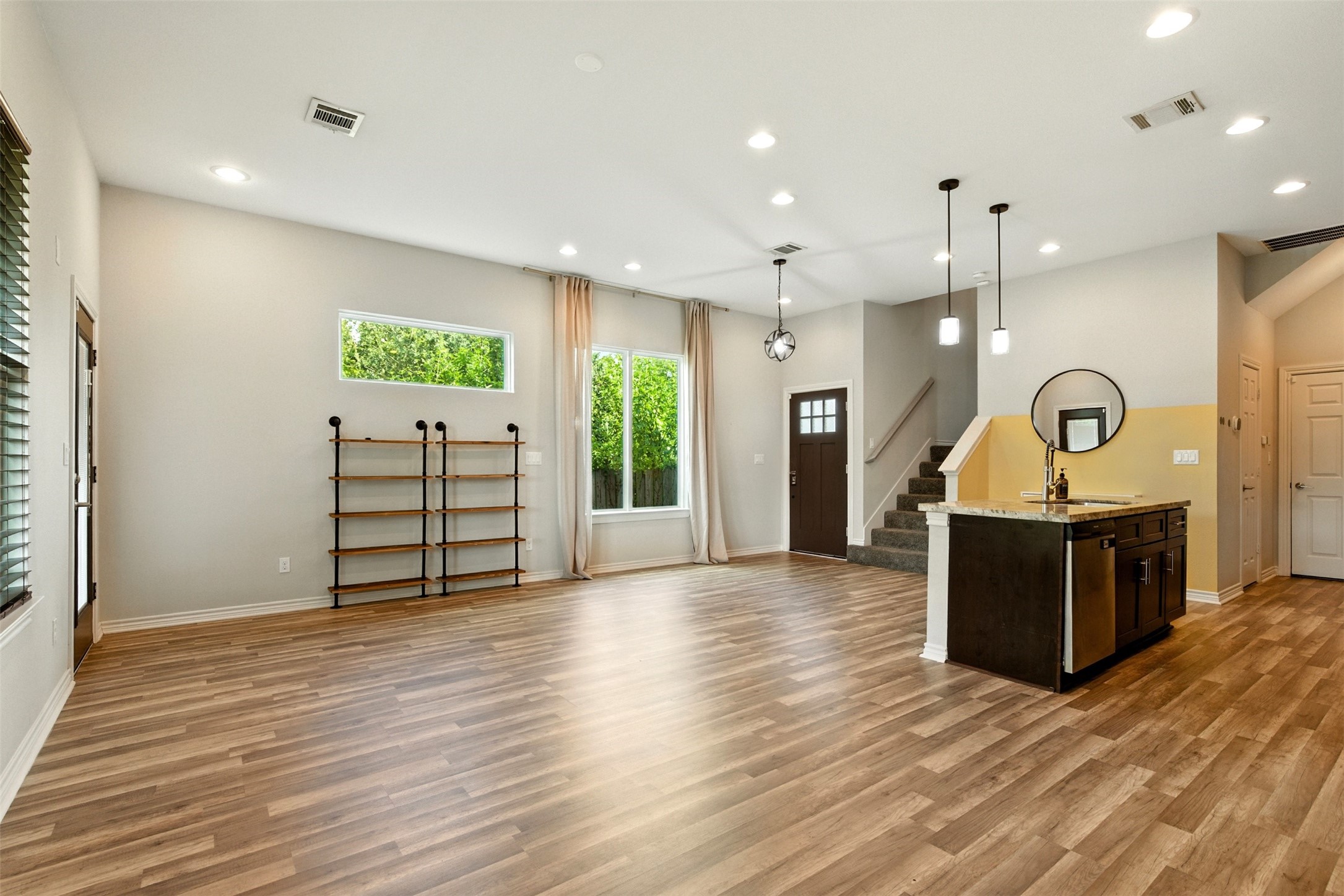 a view of a hallway with wooden floor
