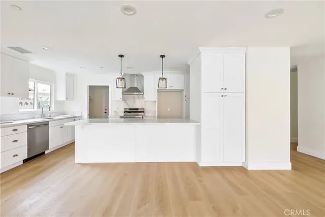 a kitchen with stainless steel appliances white cabinets and a stove