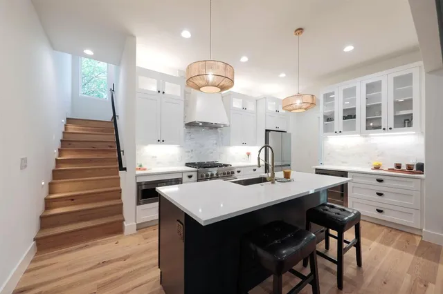 a kitchen with a sink cabinets and wooden floor