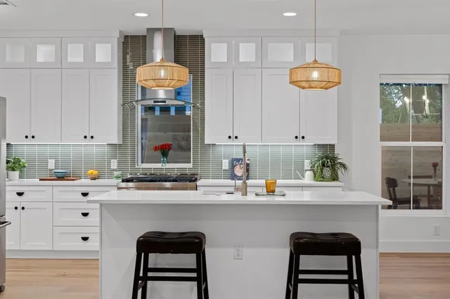 a kitchen with a sink cabinets and window