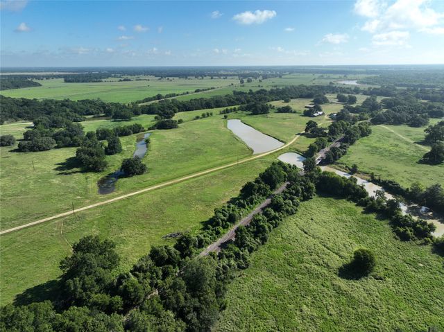 a view of a field with an ocean