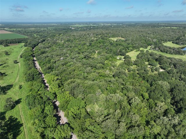a view of a green field with lots of bushes