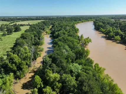 an aerial view of a houses with a yard
