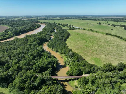 a view of a green yard with an outdoor seating
