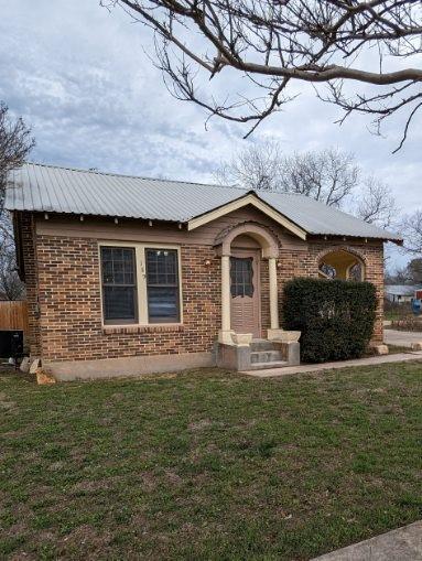 189 Norway Street Walnut Springs, TX 76690 - Photo 1 of 18 a front view of a house with a yard