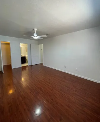 a utility room with wooden floor washer and dryer