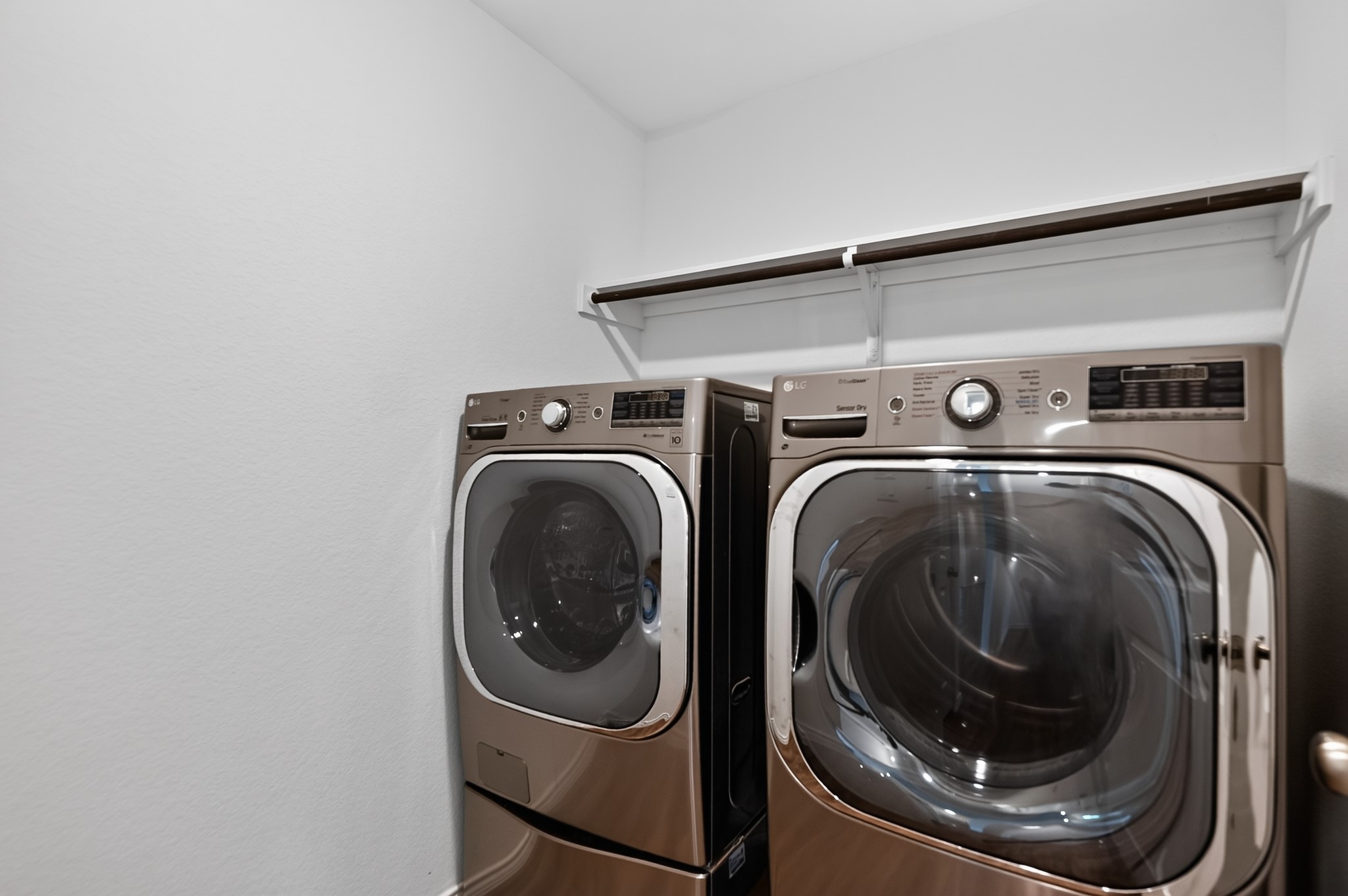 128 Konik Road Georgetown, TX 78626 - Photo 22 of 34 A well-organized laundry area featuring a washer, dryer, and convenient shelving.