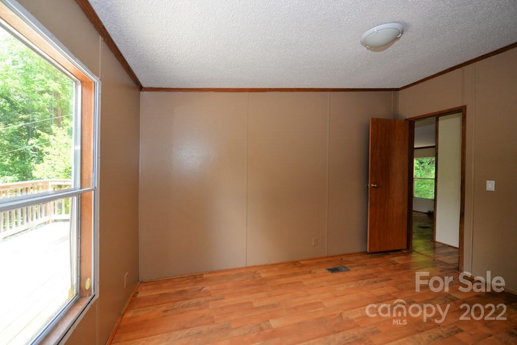 280 Lightning Bug Lane Waynesville, NC 28786 - Photo 12 of 26 a view of an empty room with a window