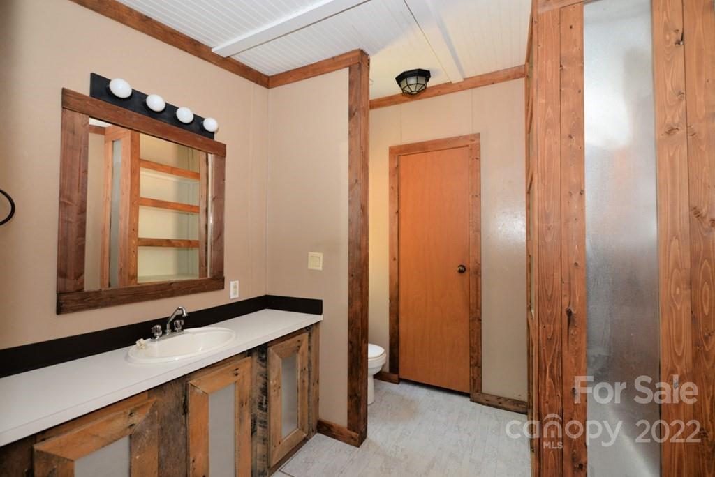 280 Lightning Bug Lane Waynesville, NC 28786 - Photo 14 of 26 a bathroom with a sink and a mirror