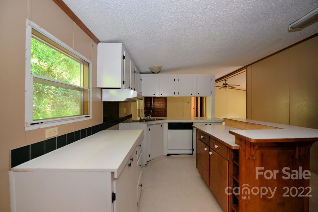 280 Lightning Bug Lane Waynesville, NC 28786 - Photo 20 of 26 a kitchen with a stove a sink and a refrigerator