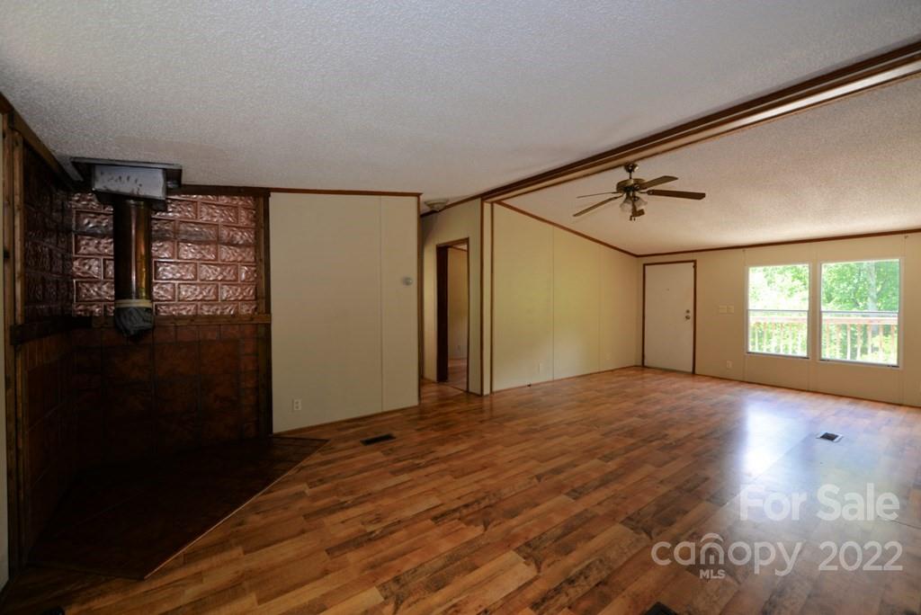 280 Lightning Bug Lane Waynesville, NC 28786 - Photo 22 of 26 a view of empty room with wooden floor and fan