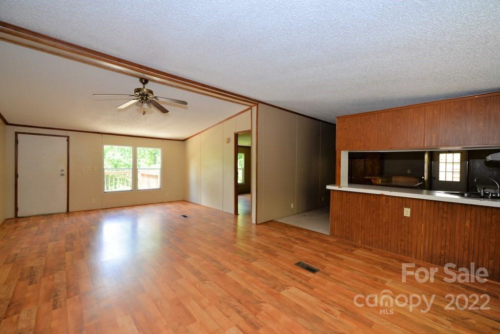 280 Lightning Bug Lane Waynesville, NC 28786 - Photo 23 of 26 a view of empty room with wooden floor and fan