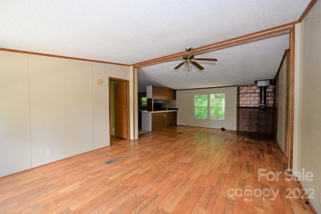 280 Lightning Bug Lane Waynesville, NC 28786 - Photo 25 of 26 a view of empty room with a ceiling fan and window