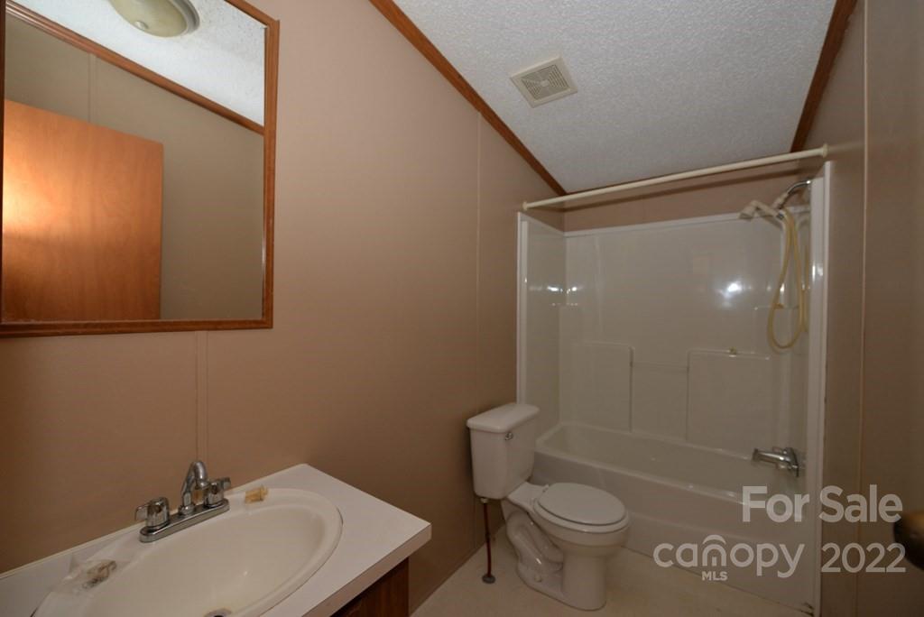280 Lightning Bug Lane Waynesville, NC 28786 - Photo 9 of 26 a bathroom with a sink toilet and shower