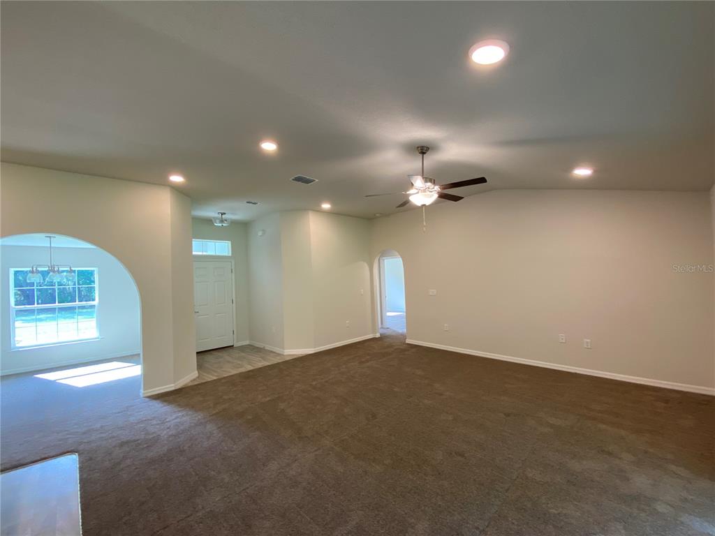16090 Southwest 55th Avenue Road Ocala, FL 34473 - Photo 2 of 28 an empty room with windows and fireplace