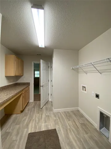a view of a kitchen with a sink and a refrigerator